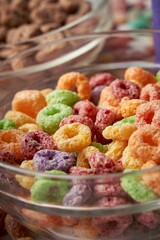 Vertical shot of a brightly colored assortment of breakfast cereals in a glass bowl