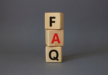 FAQ - Frequently Asked Questions symbol. Concept word FAQ on wooden cubes. Beautiful grey...