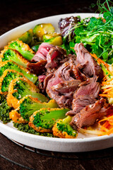 Roast beef salad with vegetables on plate