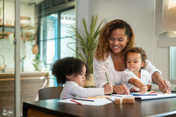 African American mother playing with her daughters in home