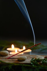 An incense stick that burns and generates smoke.