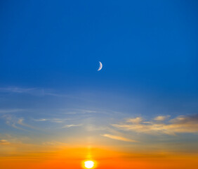 evening sun and halh moon on cloudy sky, dramatic sunset background