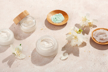 Obraz na płótnie Canvas skincare products and jasmine flowers. natural cosmetics for home spa treatment