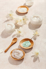 Obraz na płótnie Canvas skincare products and jasmine flowers. natural cosmetics for home spa treatment