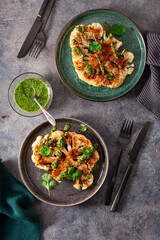 cauliflower steaks with herb sauce and spice. plant based meat substitute