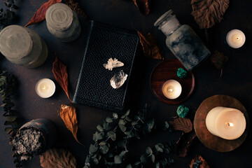 Witchcraft still life concept with potion, spell book, herbs ingredients candles and magical...