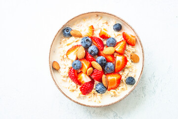 Oatmeal porrige with fresh berries and nuts.