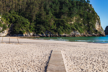 Sunny beach with mountains in the background