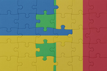 puzzle with the national flag of ukraine and mali . macro.concept.