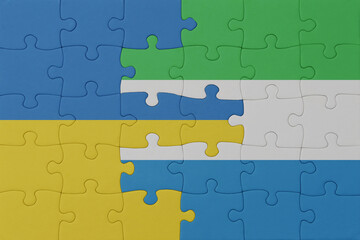 Fototapeta premium puzzle with the national flag of ukraine and sierra leone . macro.concept.