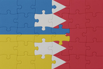 Fototapeta premium puzzle with the national flag of ukraine and bahrain . macro.concept.