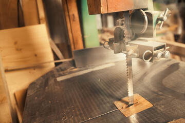 Wide-angle view of a vertical band saw and mess behind.