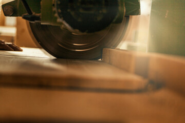 Sunbeams and dramatic atmosphere on circular saw cutting.
