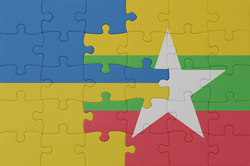 puzzle with the national flag of ukraine and myanmar . macro.concept.