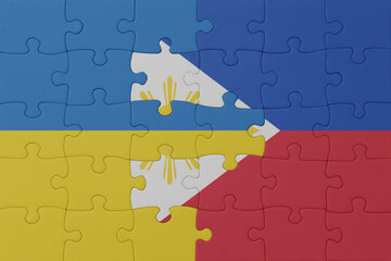 puzzle with the national flag of ukraine and philippines . macro.concept.