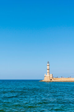Lighthouse in mediterranean sea. Holidays in Greece
