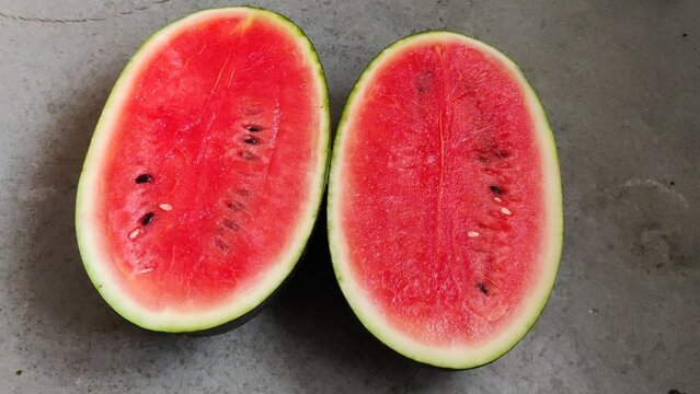 Picture of red slices of watermelon fruit cut shot during daylight in summers. Watermelon is rich in vitamins.