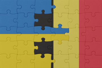 puzzle with the national flag of ukraine and belgium . macro.concept.