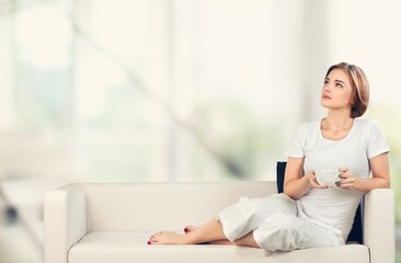 Obraz premium Relaxed young woman rest on sofa at home,