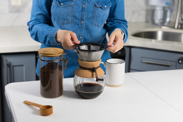 Woman making a pour over coffee at home