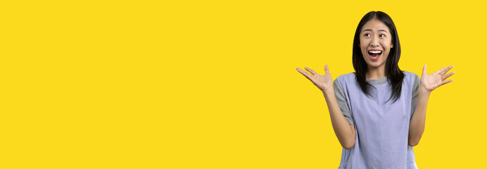 Asian woman acting shocked or surprised isolated on a white background,  Looking camera, Concept acts according to the emotions and feelings of excitement and shock, Yellow background, Copy space.