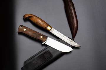 Damascus steel knives on a black background. Kitchen knives. background with japanese knife. A set...