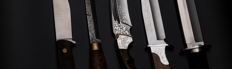 Damascus steel knives on a black background. Kitchen knives. background with japanese knife. A set...