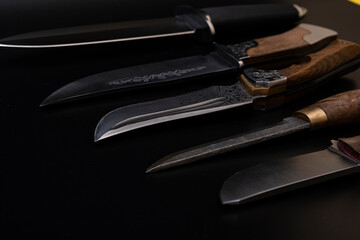 Damascus steel knives on a black background. Kitchen knives. background with japanese knife. A set of Japanese Damascus steel knives. Banner