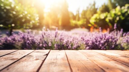 Empty wooden tabletop against the backdrop of blooming lavender fields, summer lavender fields out of focus.