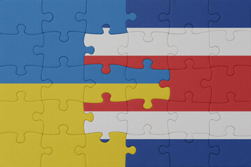 puzzle with the national flag of ukraine and costa rica . macro.concept.