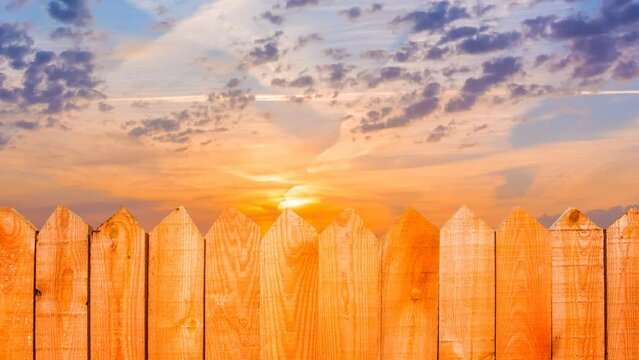  closeup wooden fence on the dramatic sunset background time lapse scene
