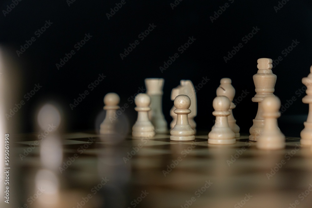 Sticker the white chess board is sitting in the dark with the pieces all aligned up