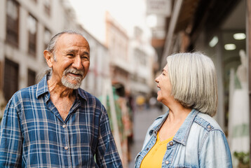 Happy senior couple having fun in city - Elderly people and love relationship concept