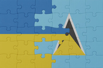 puzzle with the national flag of ukraine and saint lucia . macro.concept.