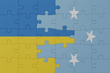 Fototapeta premium puzzle with the national flag of ukraine and Federated States of Micronesia . macro.concept.