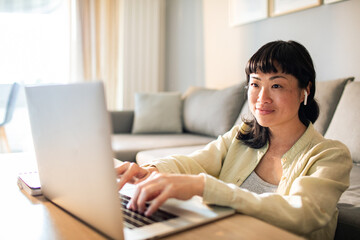 Young Japanese Woman using a laptop on a couch