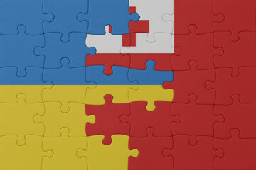 puzzle with the national flag of ukraine and Tonga . macro.concept.