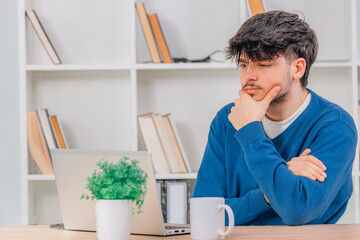 student at desk with computer or laptop