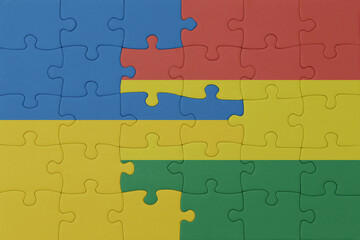 puzzle with the national flag of ukraine and bolivia . macro.concept.