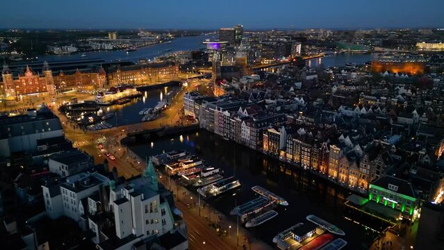 Night aerial view of Damrak canal houses in Amsterdam, Netherlands