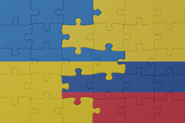 Fototapeta premium puzzle with the national flag of ukraine and colombia . macro.concept.