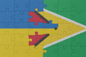 puzzle with the national flag of ukraine and guyana . macro.concept.