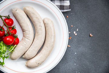 White sausage weisswurst veal, pork, lard, spices natural casing meal food snack on the table copy...
