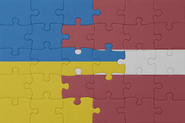 puzzle with the national flag of ukraine and latvia . macro.concept.