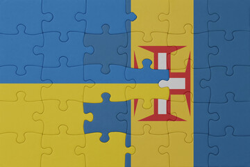 puzzle with the national flag of ukraine and madeira . macro.concept.