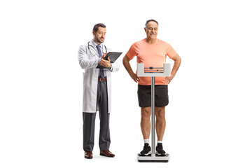 Young male doctor writing a document and a mature man weighing on a medical scale