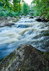 Tranquil waterfall cascading over a bed of rocks, creating a serene atmosphere