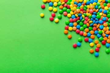 Mixed collection of colorful candy, on colored background. Flat lay, top view. frame of colorful chocolate coated candy