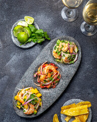 CEVICHE. Three colorful shrimps ceviche with mango, avocado and tomatoes. Latin American Mexican...