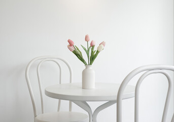 A vase of tulips on white table , in white back ground